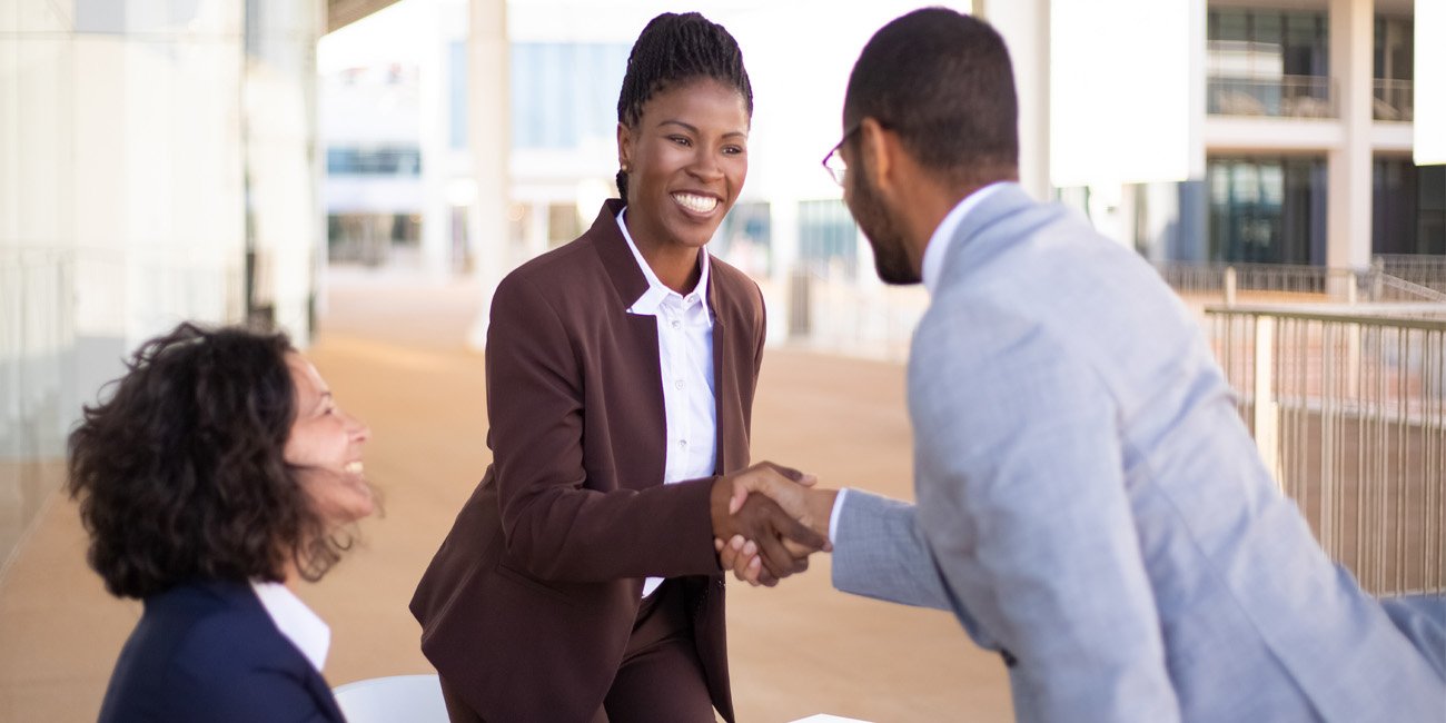 Female employer greeting male candidate